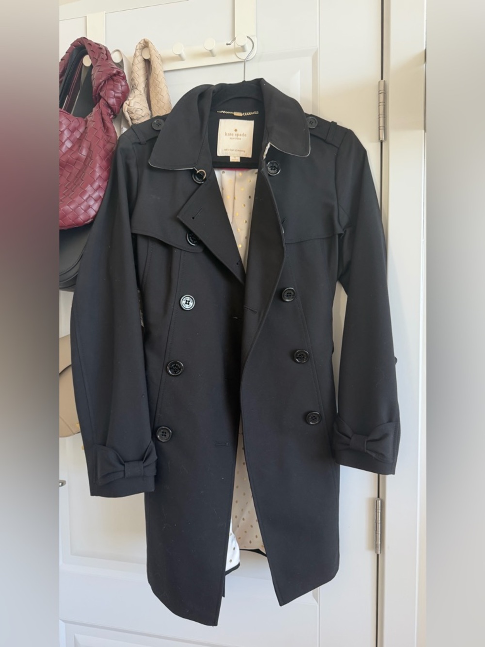kate spade black double-breasted trench with bow cuffs